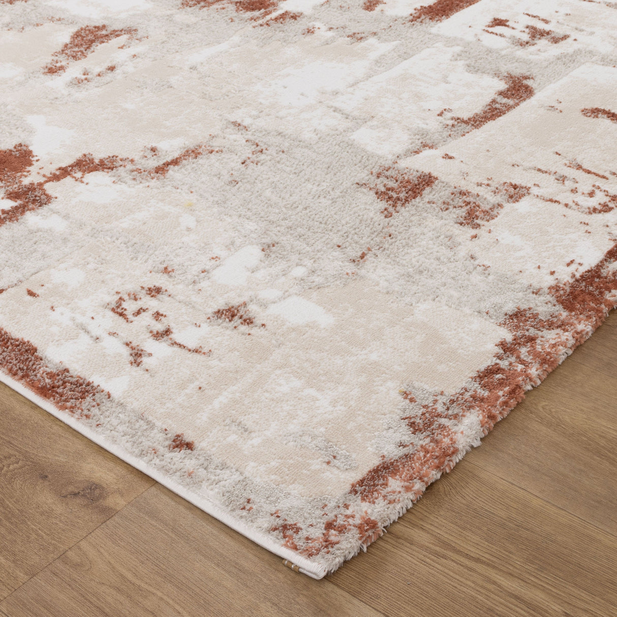 White and red patterned rug on a wooden floor