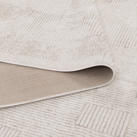 Close-up of a textured beige rug with a geometric pattern